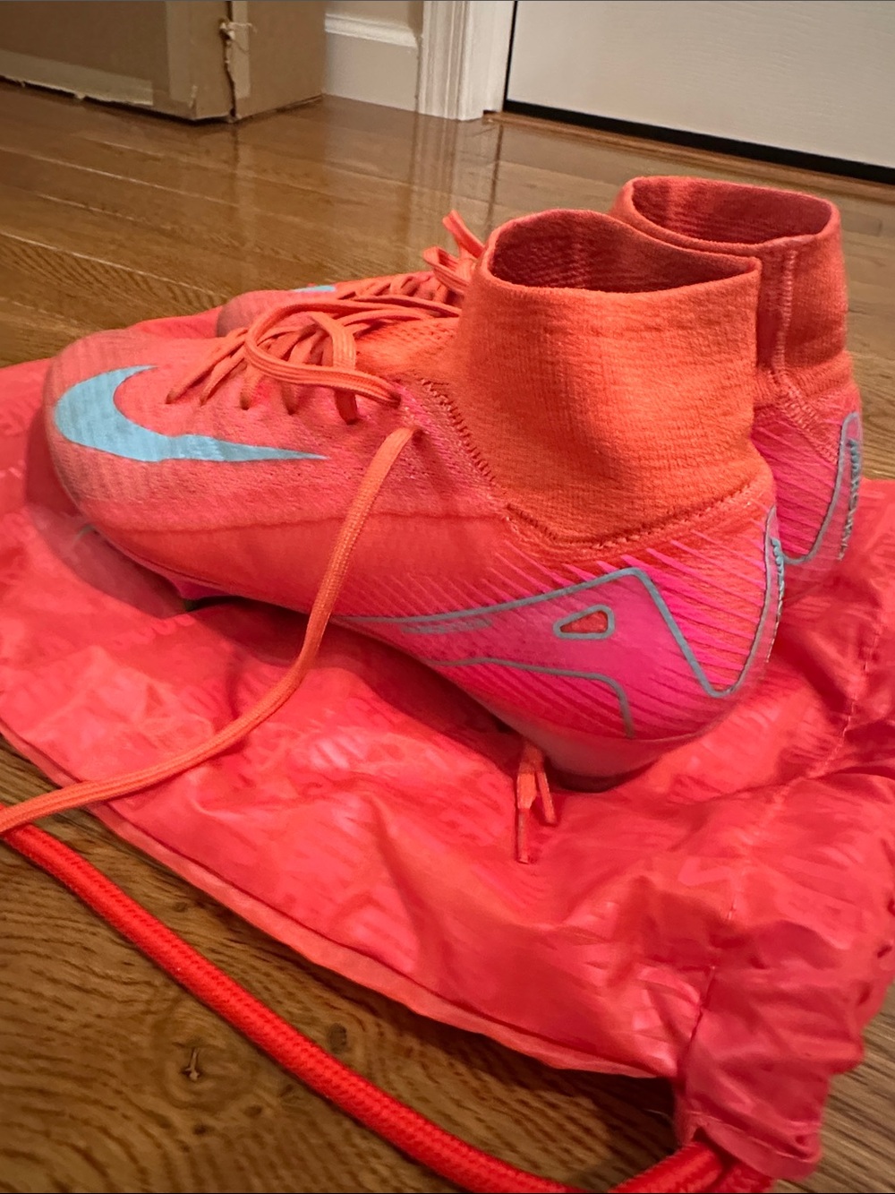 Nike Coral Pink Soccer Cleats with Sky Blue Swoosh